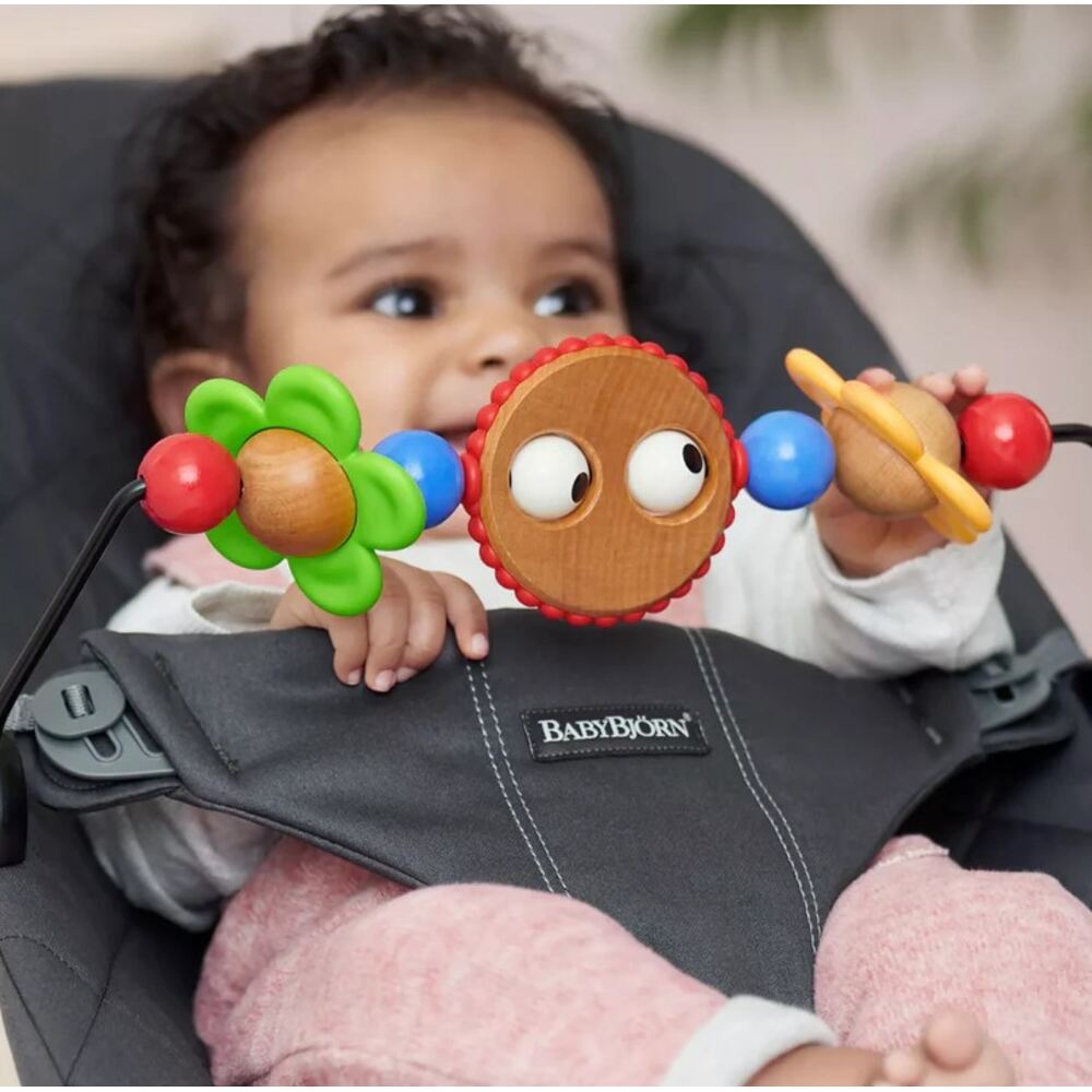 Babby sitting in Baby Bjorn Bouncer with classic toy bar