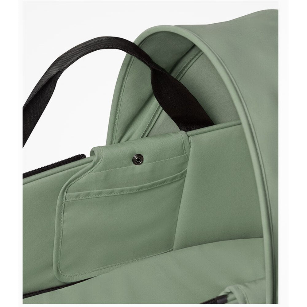 Close up of Babyzen Yoyo olive bassinet with inner pockets