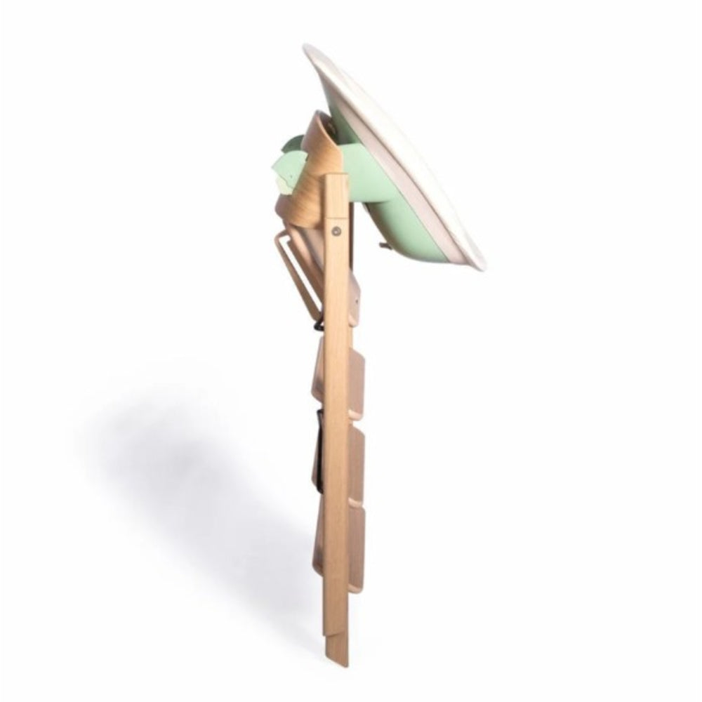 Folded wooden Klapp High Chair with Fishnet Green Klapp newborn seat in side angle.