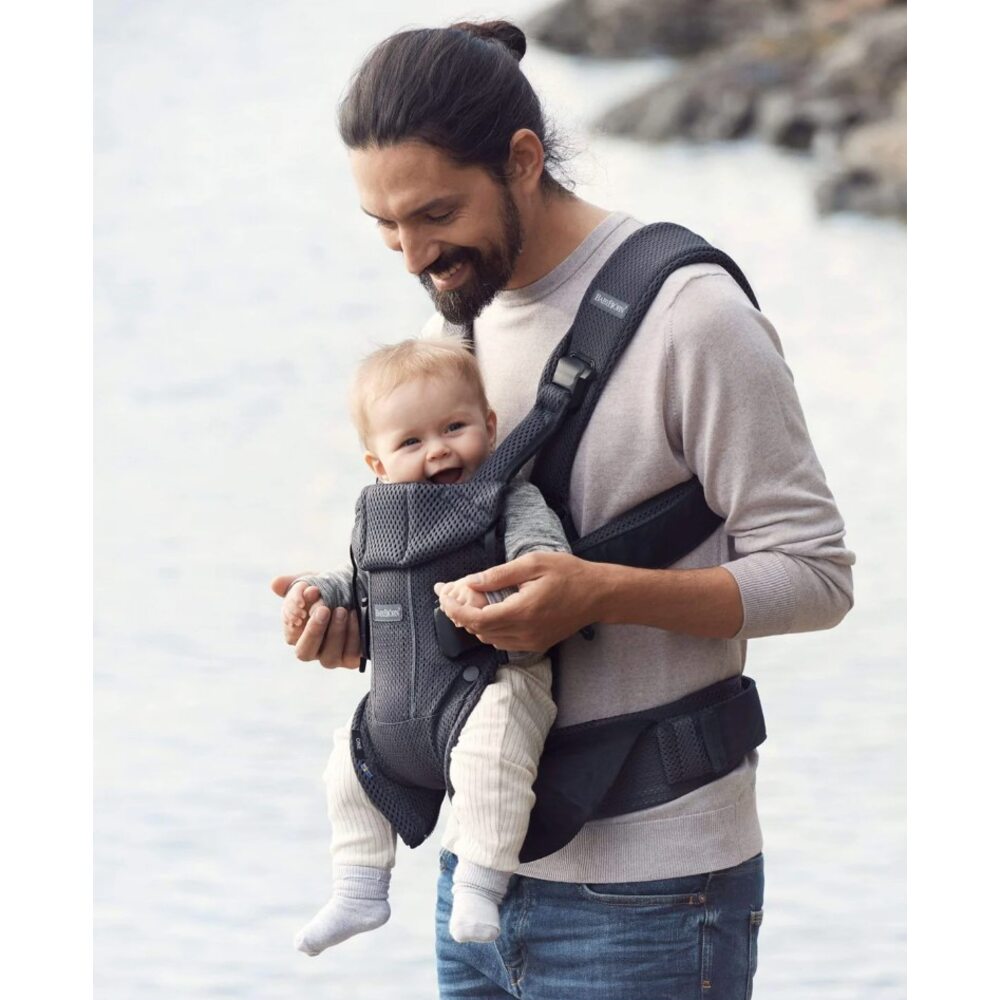 Man carrying baby in Baby Bjorn carrier One Air in black mesh