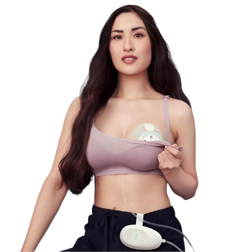 Woman wearing the Elvie Stride Breast Pump and control unit attached to her waistband