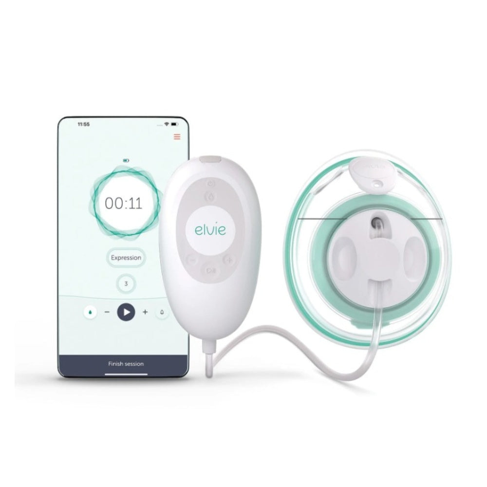 A white and green Elvie Stride Single Breast Pump positioned beside a smartphone on a flat surface.