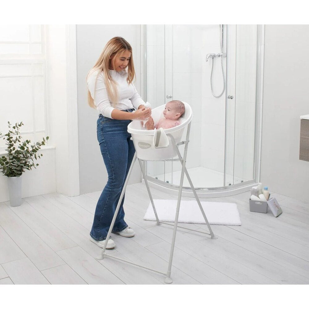 Baby bathed by woman on Shnuggle Baby Bath with stand